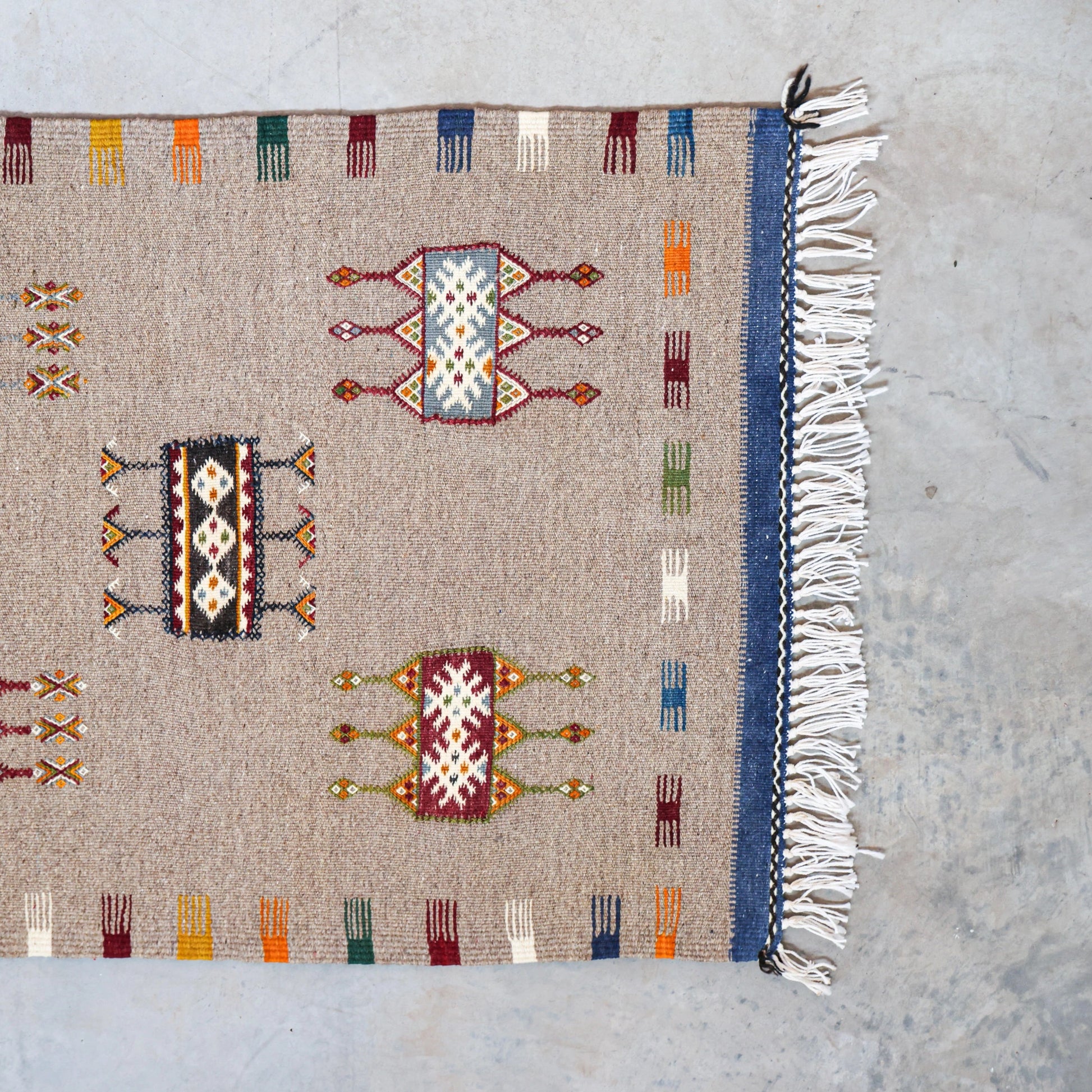 Handmade rug with geometric patterns on a plain background