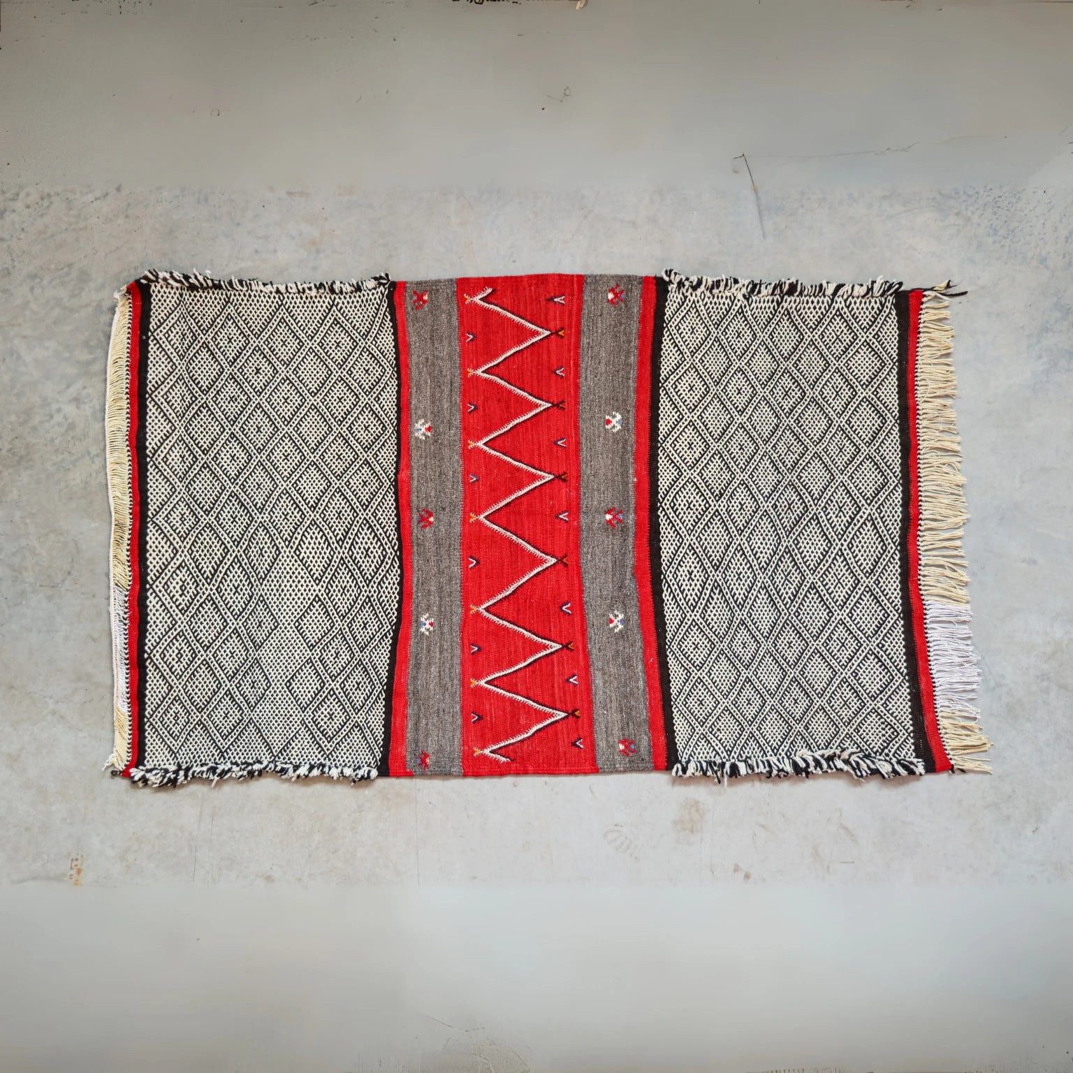 Woven textile with geometric patterns on a plain background