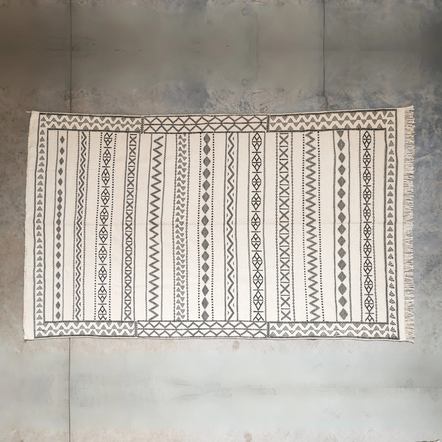 Patterned rug on a textured floor